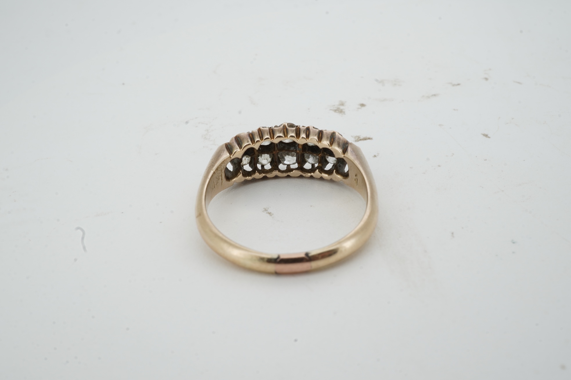 A diamond ring, early 20th century, pavé-set to the front with two rows of cushion-shaped diamonds totalling approximately 0.40 carats, mounted in gold, size O, gross weight approximately 3.5 grams